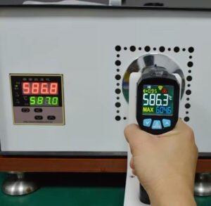 Engineers are adjusting the emissivity of the infrared thermometer.
