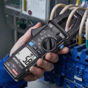 An electrician is using a Metek multimeter to measure the distribution box.