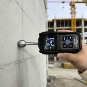 Workers are using professional moisture meters to test the moisture content of concrete.